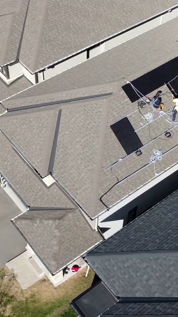 KAJK installers laying racking on an Orléans roof, seen from a drone